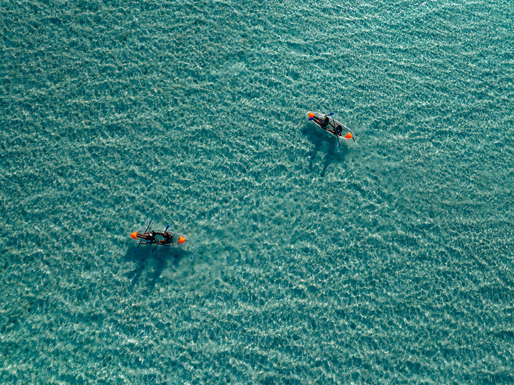 The red sea with people paddeling kayaks